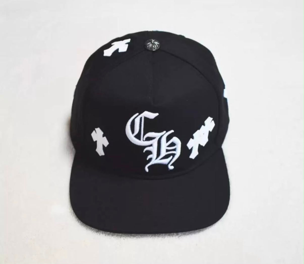 Kaizen Resellzz black Chrome Hearts trucker hat with white gothic embroidery and signature silver crown button
